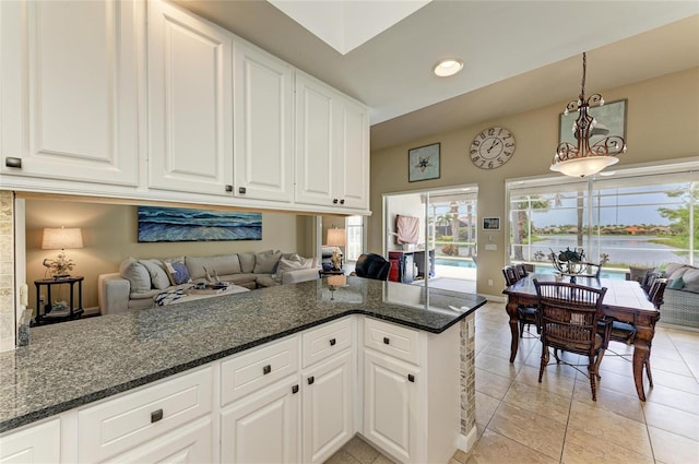 13167 Fernando St, Venice, FL 34293 - kitchen with open floor plan, light tile patterned flooring, white cabinetry, hanging light fixtures, and recessed lighting