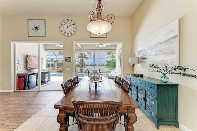 13167 Fernando St, Venice, FL 34293 - dining area featuring a ceiling fan, light wood-style floors, and baseboards
