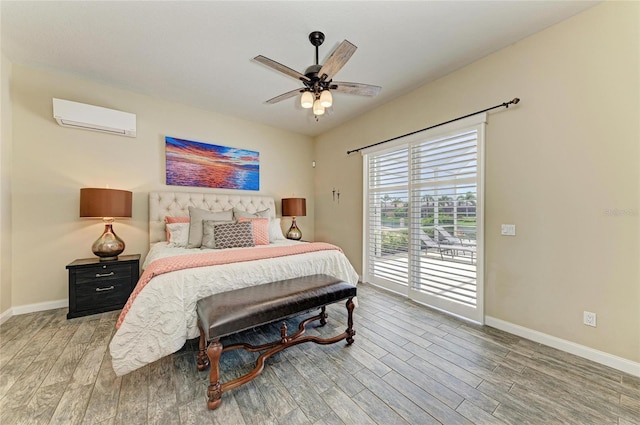 13167 Fernando St, Venice, FL 34293 - bedroom with a wall unit AC, light wood-style flooring, access to outside, and baseboards