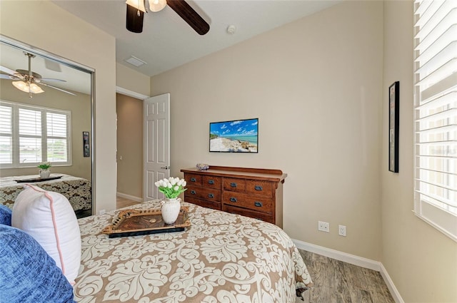 13167 Fernando St, Venice, FL 34293 - bedroom with wood finished floors, baseboards, and a ceiling fan