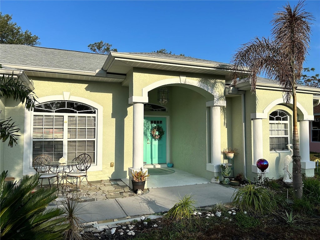 property entrance with stucco siding