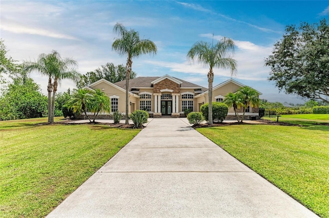 8103 Snowy Egret Pl, Bradenton, FL 34202 - view of front of house featuring french doors, stucco siding, and a front yard