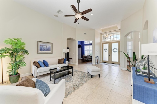 8103 Snowy Egret Pl, Bradenton, FL 34202 - living area with arched walkways, a high ceiling, a chandelier, ceiling fan, and baseboards