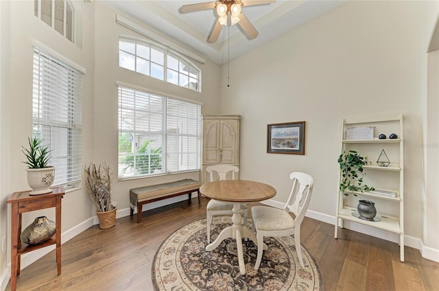 8103 Snowy Egret Pl, Bradenton, FL 34202 - dining space with ceiling fan, hardwood / wood-style floors, baseboards, and a towering ceiling