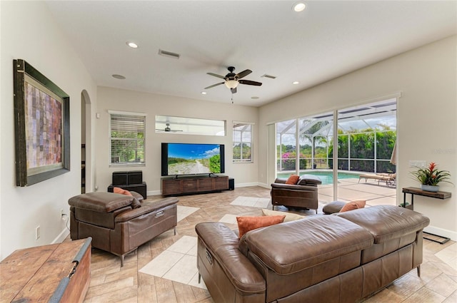 8103 Snowy Egret Pl, Bradenton, FL 34202 - living room featuring a ceiling fan, recessed lighting, baseboards, and arched walkways