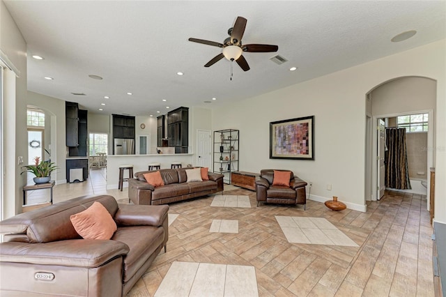 8103 Snowy Egret Pl, Bradenton, FL 34202 - living room with arched walkways, ceiling fan, healthy amount of natural light, baseboards, and recessed lighting