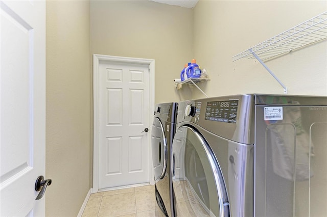 8103 Snowy Egret Pl, Bradenton, FL 34202 - washroom featuring washer and dryer, light tile patterned floors, and baseboards