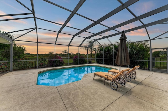 8103 Snowy Egret Pl, Bradenton, FL 34202 - pool at dusk featuring a patio area, an outdoor pool, and glass enclosure