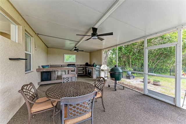 8103 Snowy Egret Pl, Bradenton, FL 34202 - sunroom with exterior kitchen, ceiling fan, and outdoor dining space