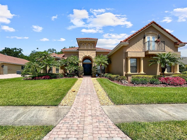 6567 Eagle Ridge Way, Lakeland, FL 33813 - mediterranean / spanish home with a balcony, stucco siding, a front lawn, and a tile roof
