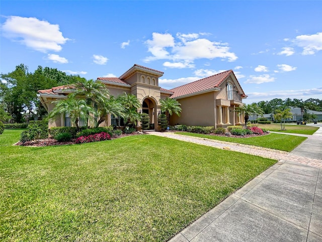 6567 Eagle Ridge Way, Lakeland, FL 33813 - mediterranean / spanish-style home with stucco siding, a front yard, and a tile roof