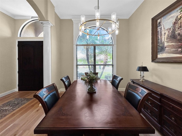 6567 Eagle Ridge Way, Lakeland, FL 33813 - dining room with decorative columns, wood finished floors, a chandelier, arched walkways, and baseboards