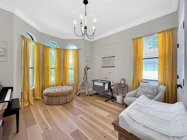 6567 Eagle Ridge Way, Lakeland, FL 33813 - living area featuring light wood-style flooring, a chandelier, crown molding, and healthy amount of natural light