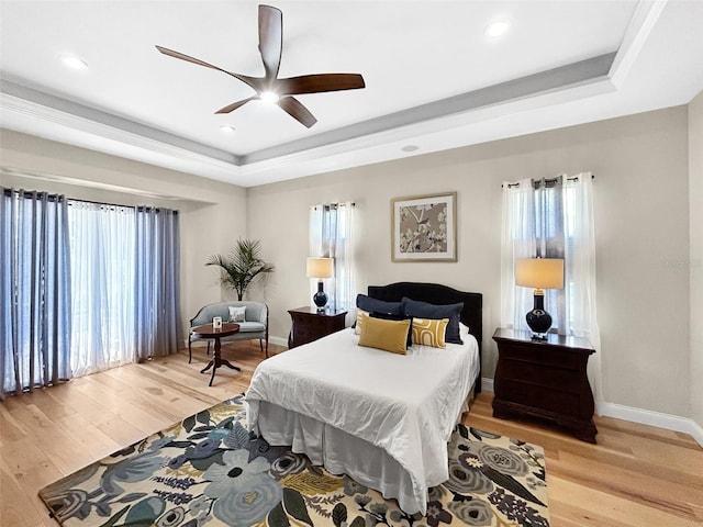 6567 Eagle Ridge Way, Lakeland, FL 33813 - bedroom featuring a raised ceiling, multiple windows, light wood-style floors, and recessed lighting