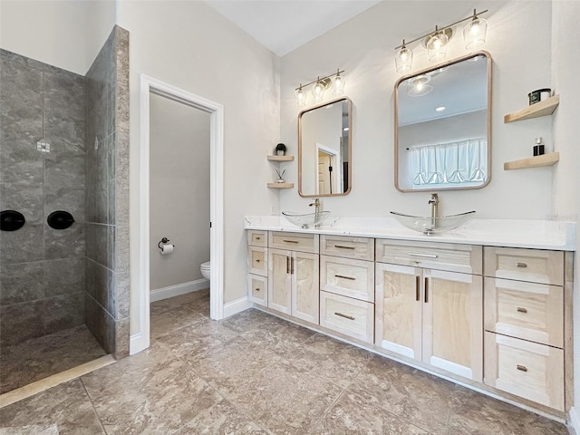 6567 Eagle Ridge Way, Lakeland, FL 33813 - bathroom featuring toilet, a tile shower, double vanity, and baseboards