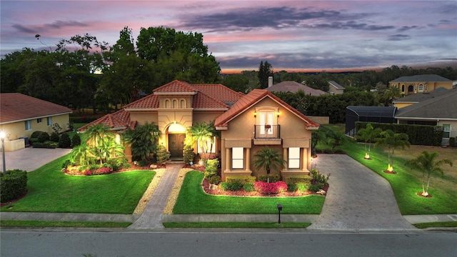 6567 Eagle Ridge Way, Lakeland, FL 33813 - mediterranean / spanish house featuring driveway, a tile roof, a front lawn, and stucco siding