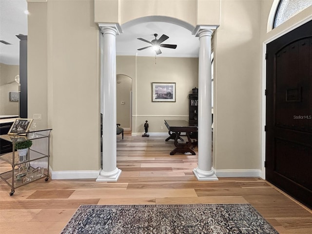 6567 Eagle Ridge Way, Lakeland, FL 33813 - entrance foyer with decorative columns, arched walkways, a ceiling fan, wood finished floors, and crown molding
