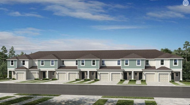 view of front of property featuring an attached garage, a residential view, and driveway