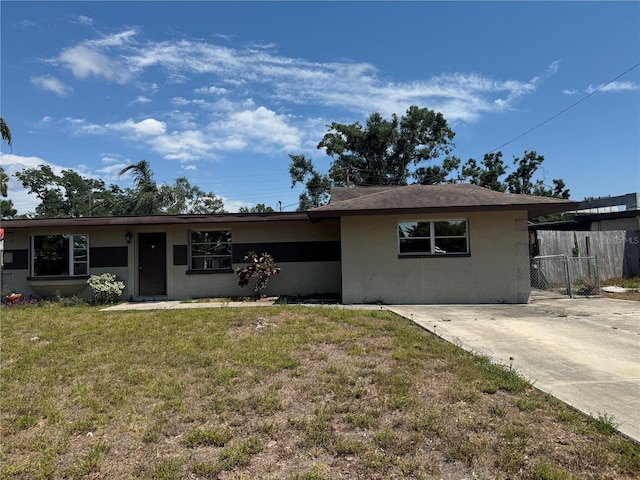 single story home featuring fence, stucco siding, and a front yard