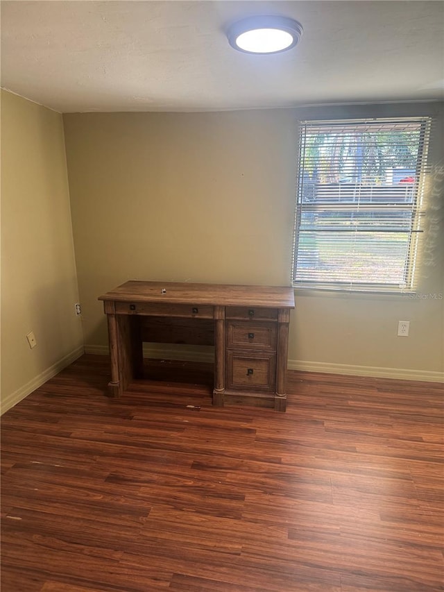 interior space with dark wood-style flooring and baseboards