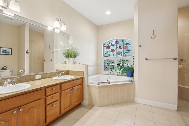 full bathroom with a sink, toilet, a garden tub, and tile patterned floors