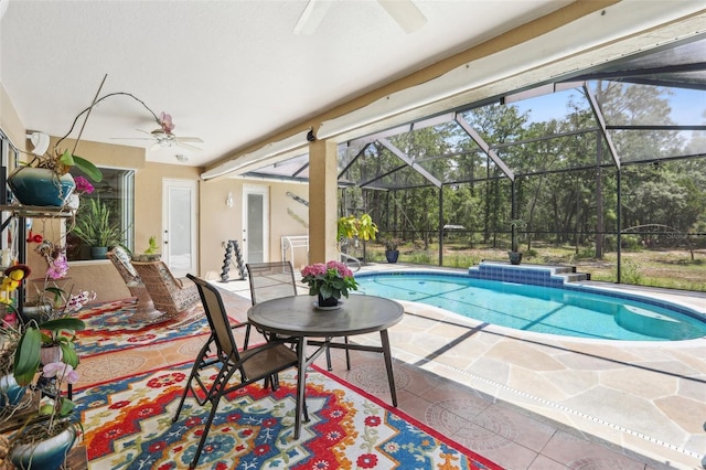 outdoor pool with ceiling fan and a patio area