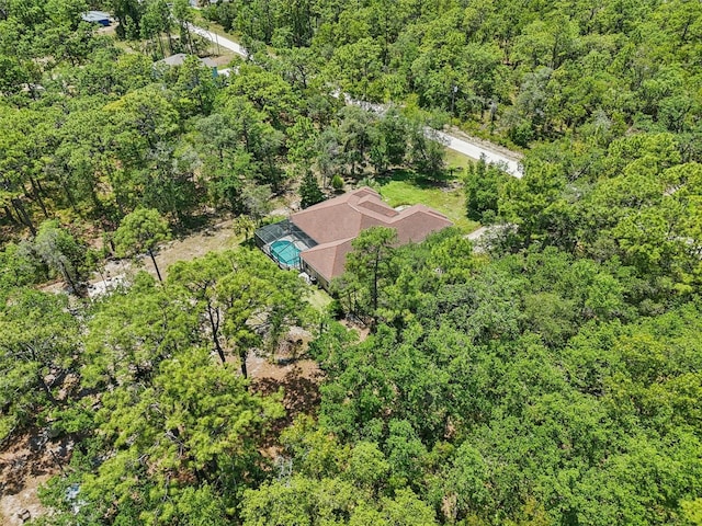 birds eye view of property with a forest view