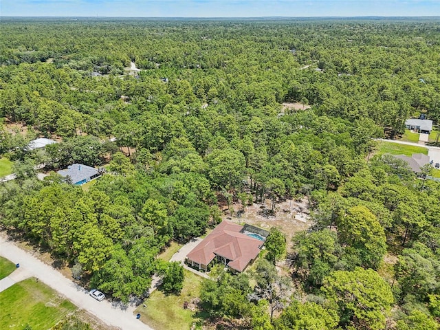 drone / aerial view featuring a view of trees