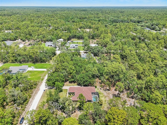 birds eye view of property with a view of trees