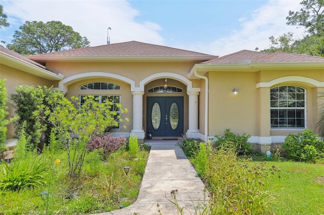 18026 Nutcracker Rd, Weeki Wachee, FL 34614 - entrance to property with stucco siding and a shingled roof