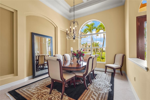 6143 9th Avenue Cir NE, Bradenton, FL 34212 - dining space with ornamental molding, light tile patterned floors, a chandelier, baseboards, and a towering ceiling