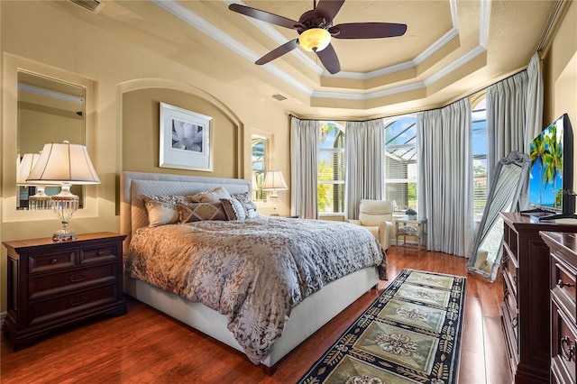 6143 9th Avenue Cir NE, Bradenton, FL 34212 - bedroom with ornamental molding, a tray ceiling, wood finished floors, and a ceiling fan