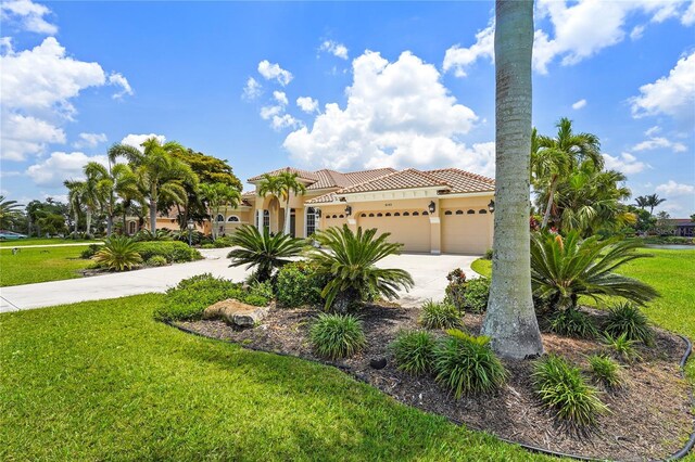 6143 9th Avenue Cir NE, Bradenton, FL 34212 - mediterranean / spanish home with driveway, a front yard, a tiled roof, and a garage