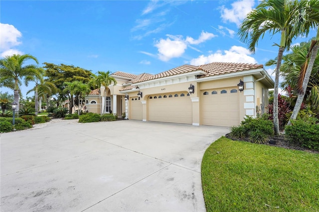 6143 9th Avenue Cir NE, Bradenton, FL 34212 - mediterranean / spanish house featuring a tile roof, a garage, concrete driveway, and stucco siding