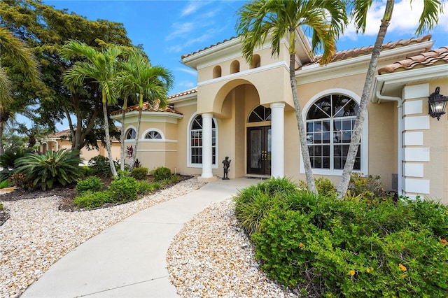 6143 9th Avenue Cir NE, Bradenton, FL 34212 - view of exterior entry with stucco siding and a tile roof