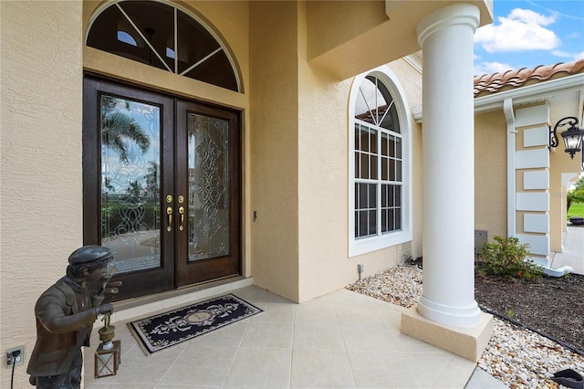 6143 9th Avenue Cir NE, Bradenton, FL 34212 - view of exterior entry with french doors, stucco siding, and a tile roof