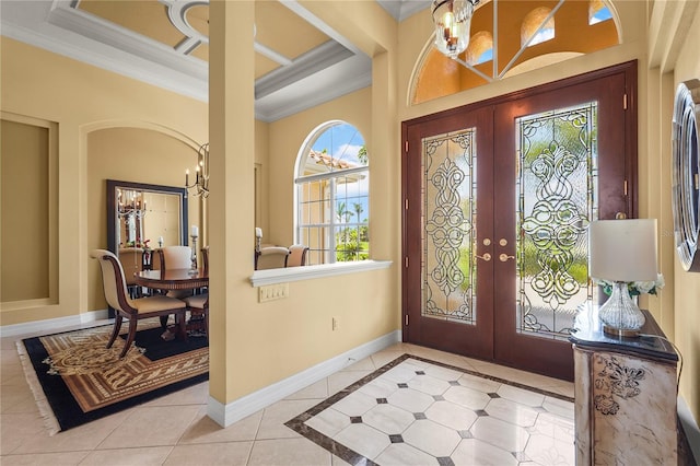 6143 9th Avenue Cir NE, Bradenton, FL 34212 - tiled foyer featuring french doors, ornamental molding, a chandelier, and baseboards