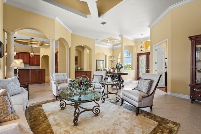 6143 9th Avenue Cir NE, Bradenton, FL 34212 - living room featuring ornate columns, crown molding, arched walkways, light tile patterned floors, and baseboards