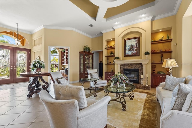 6143 9th Avenue Cir NE, Bradenton, FL 34212 - tiled living room featuring built in features, french doors, crown molding, a fireplace, and baseboards