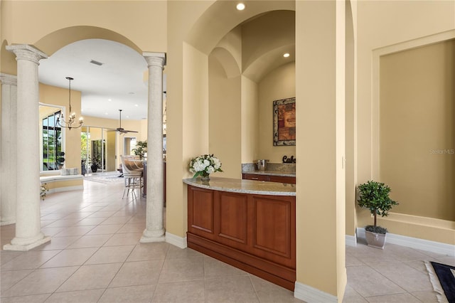 6143 9th Avenue Cir NE, Bradenton, FL 34212 - bar area with ornate columns, light tile patterned floors, recessed lighting, hanging light fixtures, and arched walkways