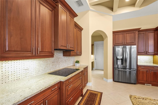 6143 9th Avenue Cir NE, Bradenton, FL 34212 - kitchen featuring stainless steel refrigerator with ice dispenser, black electric cooktop, light stone countertops, backsplash, and light tile patterned flooring