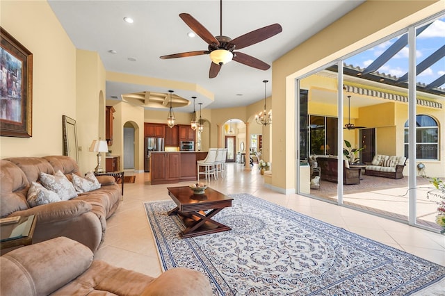 6143 9th Avenue Cir NE, Bradenton, FL 34212 - living area with arched walkways, light tile patterned flooring, a ceiling fan, a chandelier, and recessed lighting