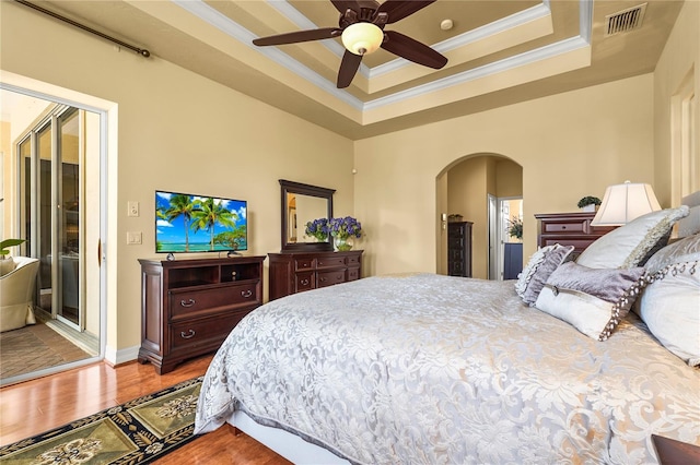 6143 9th Avenue Cir NE, Bradenton, FL 34212 - bedroom with arched walkways, crown molding, wood finished floors, a raised ceiling, and access to exterior