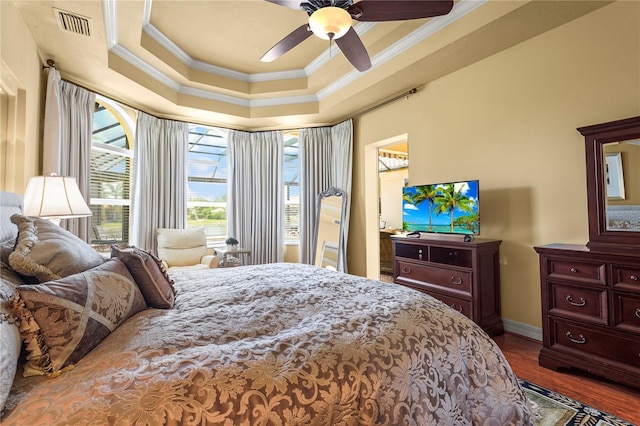 6143 9th Avenue Cir NE, Bradenton, FL 34212 - bedroom featuring crown molding, wood finished floors, baseboards, a tray ceiling, and ceiling fan
