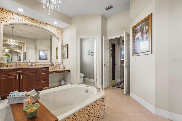 6143 9th Avenue Cir NE, Bradenton, FL 34212 - full bathroom with a chandelier, toilet, vanity, a garden tub, and baseboards