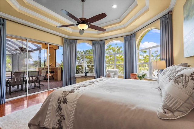 6143 9th Avenue Cir NE, Bradenton, FL 34212 - bedroom featuring crown molding, access to exterior, a raised ceiling, recessed lighting, and wood finished floors