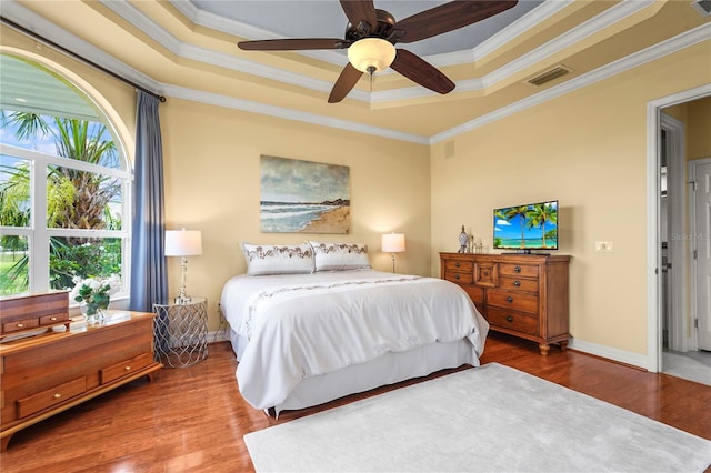 6143 9th Avenue Cir NE, Bradenton, FL 34212 - bedroom with a raised ceiling, crown molding, wood finished floors, a ceiling fan, and baseboards