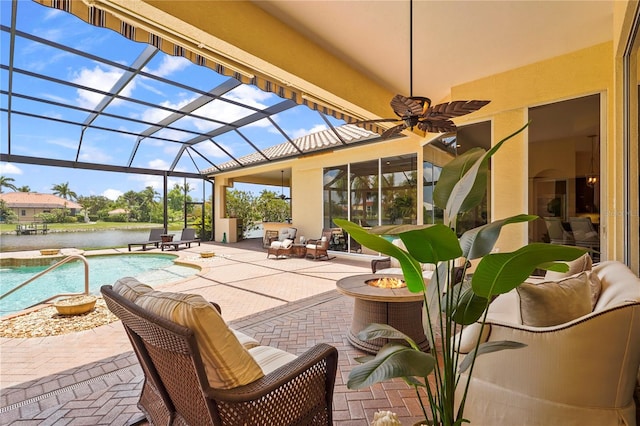6143 9th Avenue Cir NE, Bradenton, FL 34212 - view of patio featuring a ceiling fan, an outdoor pool, glass enclosure, an outdoor fire pit, and a water view