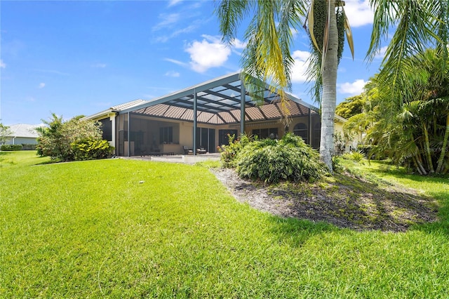 6143 9th Avenue Cir NE, Bradenton, FL 34212 - back of house with a yard and glass enclosure