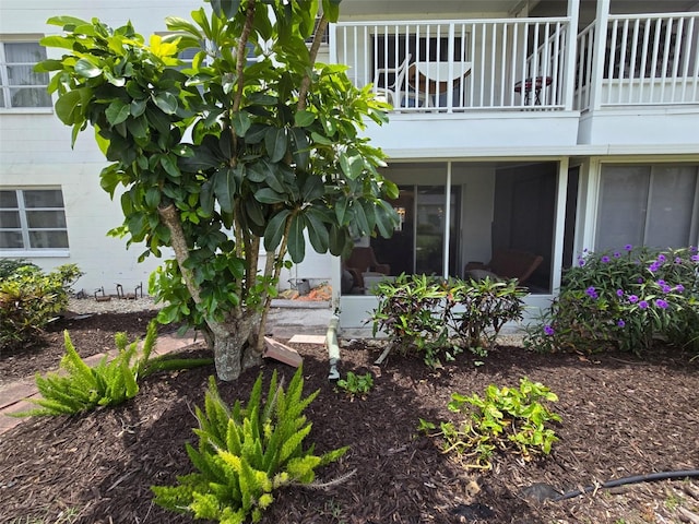 exterior space with concrete block siding and a balcony
